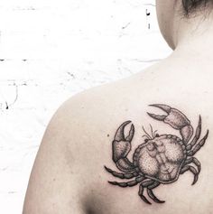 a woman with a crab tattoo on her back