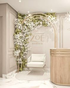 a white chair sitting in front of a wall with flowers on it and an arch