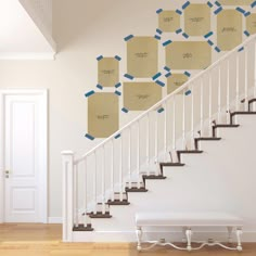 a stair case with sticky notes attached to the wall next to a white banister