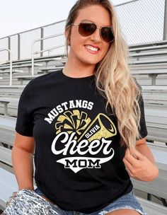 a woman wearing sunglasses and a t - shirt that says, must anggs cheer mom