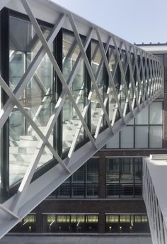 an architectural view of the outside of a building with glass and steel details on it