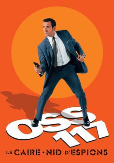 a man in a suit and tie standing next to an orange background with the words ossi on it