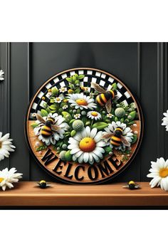 a welcome sign with daisies and bees on it