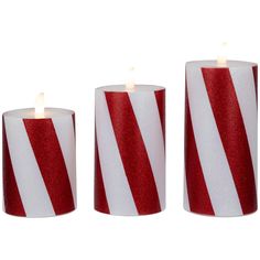 three candles with red and white stripes on them