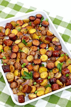 roasted potatoes in a white dish on a green and white checkered tablecloth