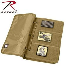 a wallet that has some patches on it and is open to show the contents inside