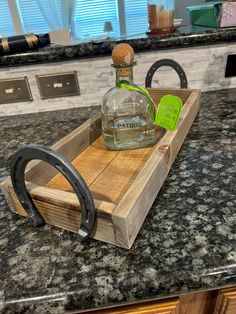 a bottle of patron sitting on top of a wooden tray