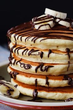 a stack of pancakes with chocolate drizzled on top and the words easy banana pancakes