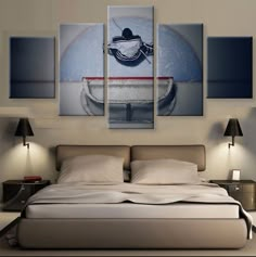 a bed with three paintings on the wall above it