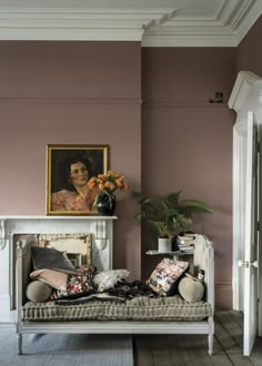 a living room filled with furniture and a painting on the wall