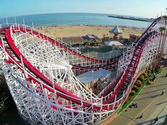 an aerial view of a roller coaster on the beach