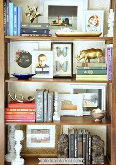 a bookshelf filled with lots of books and pictures