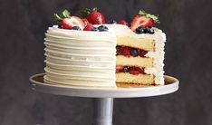 a cake with white frosting and strawberries on top