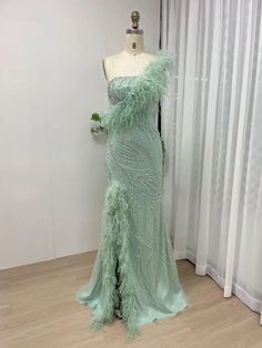 a dress on a mannequin in front of a window