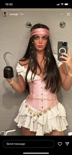 a woman in a pink corset and headband is holding an umbrella while taking a selfie