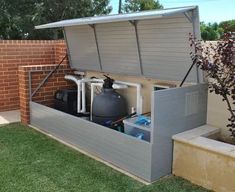 an outdoor storage unit with water tanks and other items in it's back yard