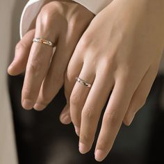 two women's hands with wedding rings on their fingers