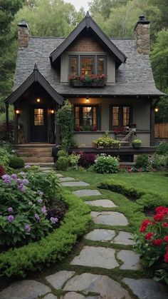 a house that is surrounded by flowers and plants