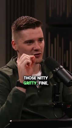 a man sitting in front of a microphone with the words those nitty, gritty, fine