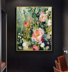 a painting hanging on the wall next to a chair