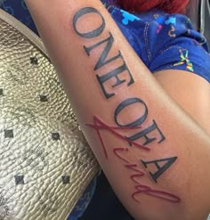 a woman with a tattoo on her arm that reads,'aloha '