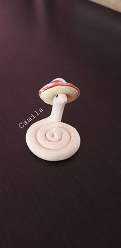 a small mushroom sitting on top of a wooden table