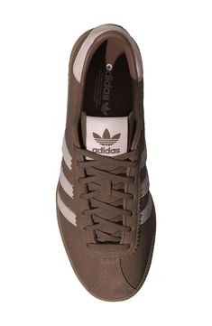 The brand with the 3-Stripes dips into their '80s archives to reimagine this smooth suede sneaker set on a rubber gum sole that stays true to the authentic adidas look. Lace-up style Leather upper/textile and synthetic lining/rubber sole Imported