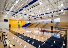 several people are playing basketball in an empty gym