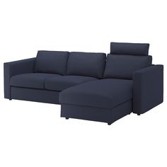 a blue sectional couch sitting on top of a white floor