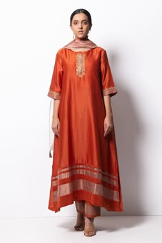 Rust orange kurta highlighted with zardozi embroidery, round neckline and straight silhouette. Comes with cotton silk pant, chanderi dupatta and inner slip.
Component: 4
Pattern: Embroidered
Type Of Work: Zardozi
Neckline: Round
Sleeve Type: Three Quarter
Fabric: Kurta: Handwoven Chanderi Silk; Dupatta: Chanderi; Pant: Cotton Silk
Color: Orange
Other Details: 
Straight kurta
Concealed placket
Side pockets
Asymmetric hem
Contrast hem pant
Dupatta with tassels
Occasion: Mehendi and Haldi, Puja - A Silk Kurta Set, Zardozi Embroidery, Cotton Kurti Designs, A Line Kurta, Silk Kurta, Kurta Designs Women, How To Hem Pants, Silk Dupatta, Suit Designs