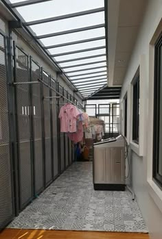 an empty hallway with clothes hanging out to dry