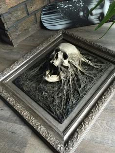 a skull in a frame on the floor