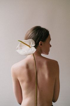 a woman with a flower on her back