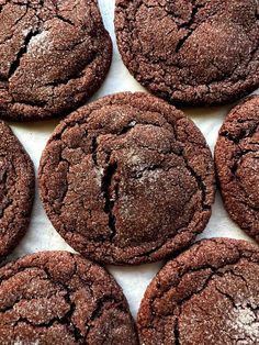 chocolate cookies with powdered sugar on top are arranged in a gridded pattern, ready to be eaten