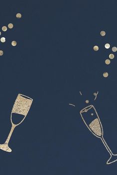 two champagne flutes with confetti falling from them on a dark blue sky background