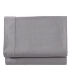 the grey sheets are folded and ready to be used as bedding or pillowcases