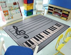 a music themed area rug in a child's room with chairs and desks