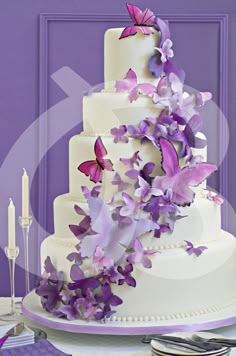 a wedding cake with purple butterflies on it