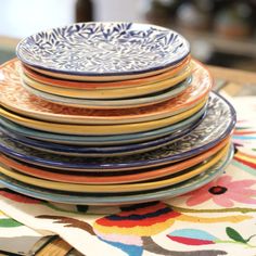 a stack of colorful plates sitting on top of a table