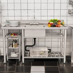 an industrial kitchen with stainless steel appliances and white tiled walls, black tile flooring