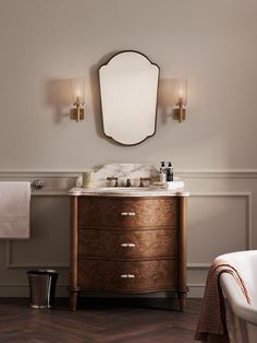 a bathroom with a sink, mirror and bathtub in the middle of the room