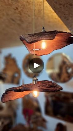 a wooden object hanging from the ceiling with lights on it's sides and two mirrors in the background