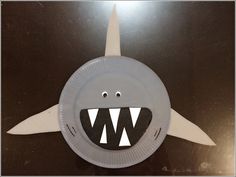 a close up of a paper plate with a shark on it's face and teeth