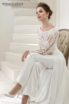 a woman sitting on top of a chair wearing a white dress