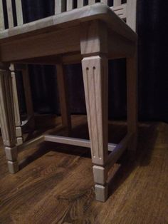 a wooden chair sitting on top of a hard wood floor