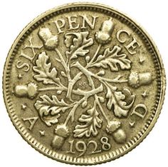 an old coin with leaves on the front and bottom, is shown in this image