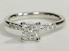 a white gold ring with a princess cut diamond