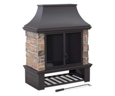 an outdoor fireplace with a chimney and grill on the side, next to it's shelf