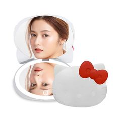 PRICES MAY VARY. 𝐂𝐋𝐀𝐒𝐒𝐘 𝐂𝐎𝐌𝐏𝐀𝐂𝐓 𝐌𝐈𝐑𝐑𝐎𝐑: The Hello Kitty Kawaii Compact Mirror can be a magical addition to your vanity. It is elegantly designed with a 1x and 2x top magnifying mirror 𝐀𝐃𝐉𝐔𝐒𝐓𝐀𝐁𝐋𝐄 𝐈𝐋𝐋𝐔𝐌𝐈𝐍𝐀𝐓𝐄𝐃 𝐋𝐈𝐆𝐇𝐓𝐒: This Hello Kitty vanity mirror will enable you to choose the brightness of the lights. You can easily switch between warm and white glow adjusting to daylight or dark 𝐒𝐄𝐍𝐒𝐈𝐓𝐈𝐕𝐄 𝐓𝐎𝐔𝐂𝐇 𝐒𝐂𝐑𝐄𝐄𝐍: The Hello Kitty compact mirr Compact Mirror Kawaii, Vanity Hello Kitty, Hello Kitty Mirror, Hello Kitty Videos, Impressions Vanity, Pocket Vase, Desk Mirror, Led Makeup Mirror, Vanity Accessories