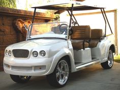 a white golf cart parked in front of a building